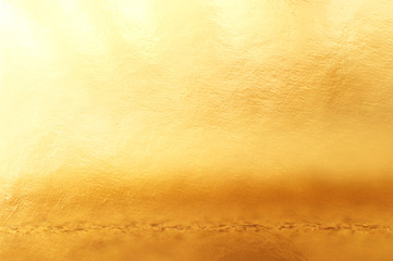 background of gold foil texture with light reflections
