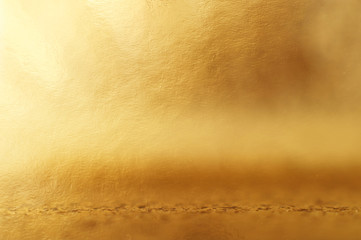 background of gold foil texture with light reflections