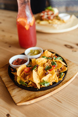 nachos tacos with meat, chili, guacamole sauce