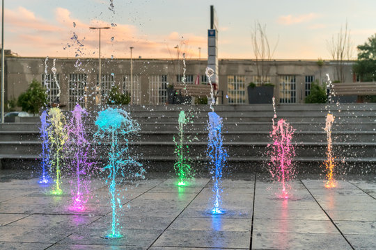 Colourful fountain in the city square 
