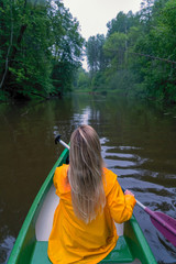 Girl in canoe at the misty river