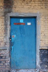  Old vintage wall with worn metal door