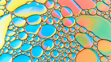Colorful abstract images of oil drops on water. Colored circles and waves as a concept of...