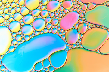 Colorful abstract images of oil drops on water. Colored circles and waves as a concept of...