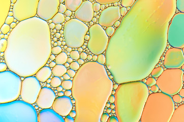 Colorful abstract images of oil drops on water. Colored circles and waves as a concept of...