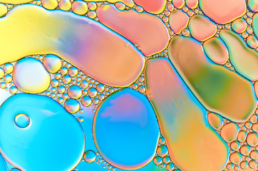 Colorful abstract images of oil drops on water. Colored circles and waves as a concept of...
