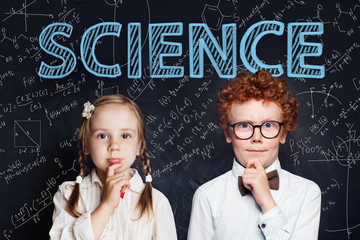Thinking children school student on background with science and maths formulas