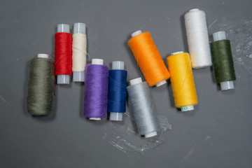 Multi-colored threads on a gray background