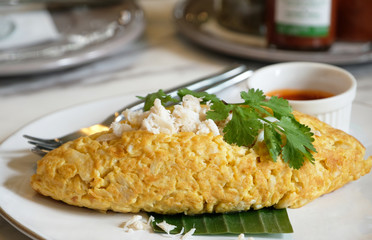 closeup crab omelette with chili sauce