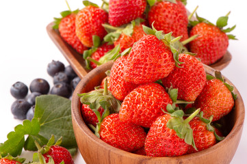 A bowl set of beautiful and delicious strawberry and blueberry isolated on white background, close up, copy space, clipping path, cut out.