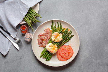 Benedict poached eggs with bacon and fried asparagus for breakfast
