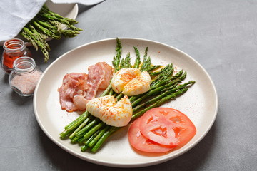 Benedict poached eggs with bacon and fried asparagus for breakfast