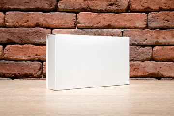 White cardboard box isolated on brick wall background, mock up