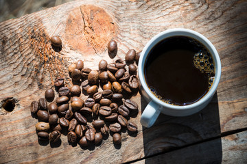 coffee Cup and coffee beans on wooden background