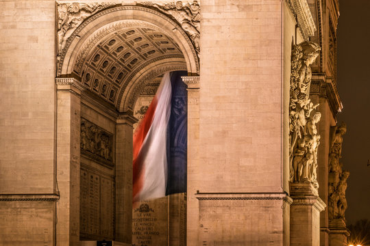Arc De Triomphe In Paris With Flag