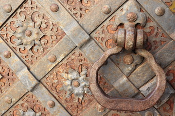 Old wooden door with metal lock and stamping