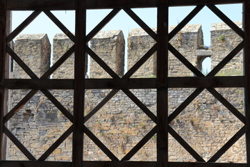 View of the castle wall through the metal lattice