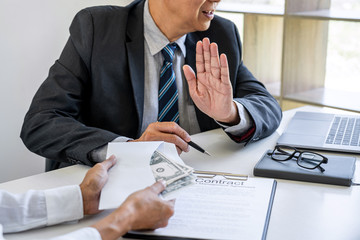 Anti Bribery and corruption concept, bribe in the form of dollar bills, consultant refuse receive...