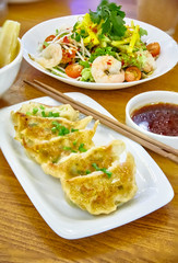 Have gyoza or fried dim sums are on a plate in the restaurant