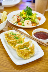 Have gyoza or fried dim sums are on a plate in the restaurant