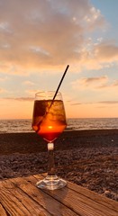 glass of orange juice on the beach