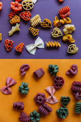 Fototapeta na wymiar Multicolored pasta shapes on colorful background. 