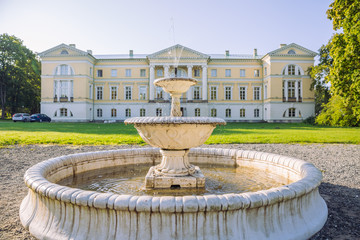 City Mezotne, Latvia Republic. Park with old castle. Fountain and green zone. Sep 9. 2019 Travel photo.