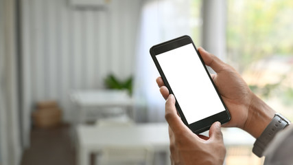 Mockup smartphone on man hands with isolated screen in cafe.