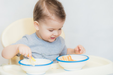 the kid in the kitchen eats milk porridge