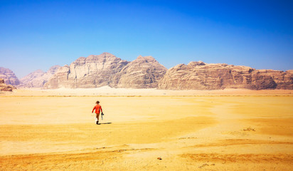Photographer walking through the desert