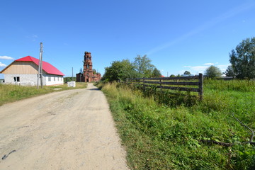 Fototapeta na wymiar intersection: the road, the fence, the trail from the jet plane and the church tower directed towards the sky begin at one point