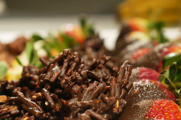 Chocolate crackles with strawberries in the background