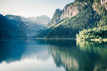 Bright summer scene of Vorderer ( Gosausee ) lake with Dachstein glacier on background. Attractive morning view of Austrian Alps, Upper Austria, Europe. Instagram filter toned.