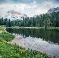 Marvelous summer scene of Antorno lake with Tre Cime di Lavaredo (Drei Zinnen) mount in the morning mist. Splendid summer view of Dolomite Alps, Italy, Europe. Beauty of nature concept background.