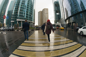 Workout time. Working day had been finished, people leave office in MIBC (Moscow International Business Center). Rainy autumn business concepts. Fish eye technique/ lens.