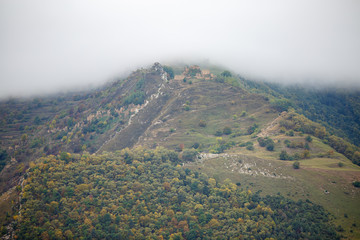 Image of picturesque mountain terrain with green vegetation with smog on summer