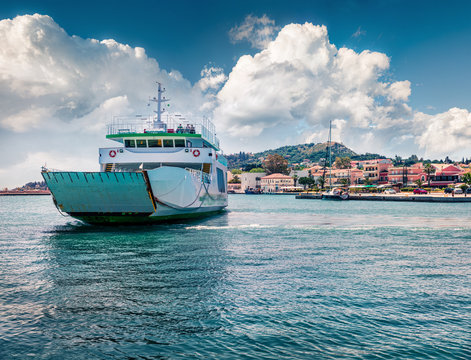 Captivating morning view of Lixouri port. Colorful spring seascape of Ionian Sea. Spectacular outdoor scene of Cephalonia island with big ferry ship on background.