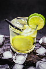 Caipirinha, a typical Brazilian cocktail made with lemon, cachaça, sugar and ice. Brazilian traditional drink, isolated with space for text.