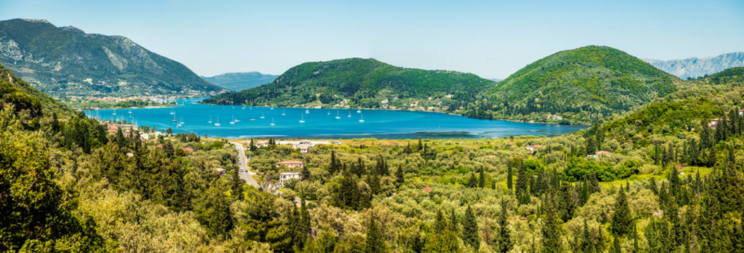 Panoramic view of Nydri port. Bright spring seascape of Ionian Sea. Colorful morning scene of Lefkada island, Greece, Europe. Traveling concept background.