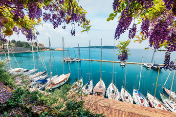 Nice view of the capital of Corfu island. Colorful spring cityscape of port of Kerkira town. Sunny morning seascape of Ionian Sea, Greece, Europe. Traveling concept background.
