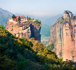 Great spring view of famous Eastern Orthodox monasteries listed as a World Heritage site, built on top of rock pillars. Colorful outdoor scene of Kalabaka location, Trikala regional unit,  Greece.