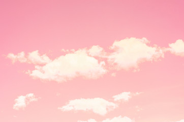 Pink sky and white clouds against blurred pattern background