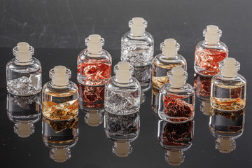 macro metal silver, gold, copper in a capsule on a gray background