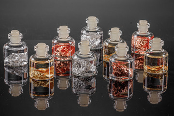 macro metal silver, gold, copper in a capsule on a gray background