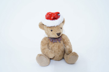 Christmas teddy bear wearing a Santa Claus hat isolated on white background, cut out.