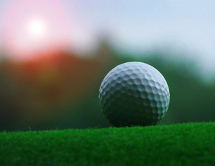 Golf on the green on a green field background with natural skies That is quite dark closely