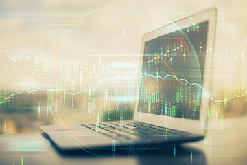 Financial graph colorful drawing and table with computer on background. Multi exposure. Concept of...