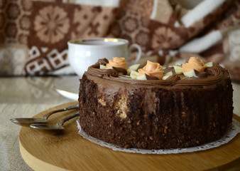 Cake with nuts and meringues decorated with cream rose. Shallow depth of field, close-up.