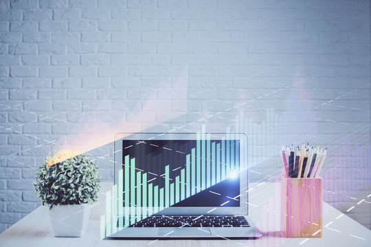 Financial graph colorful drawing and table with computer on background. Multi exposure. Concept of international markets.