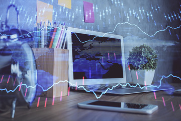 Financial chart drawing and table with computer on background. Double exposure. Concept of international markets.